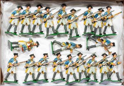 many figurines of soldiers that are in a box