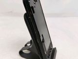 a close up of a cell phone on a stand on a table