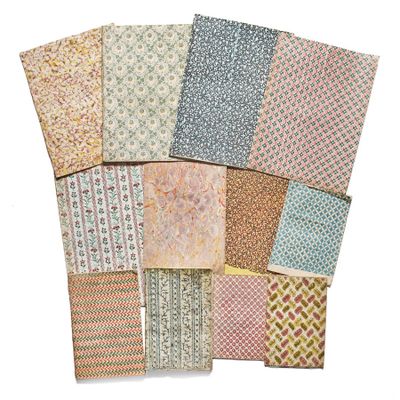 a pile of assorted patterned papers on a white background