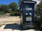 a trash can sitting on the side of the road