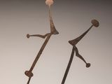 sculpture of a man and a woman holding hands on a white surface