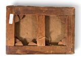 an old wooden box with a hole in it on a white surface