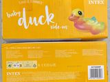 two boxes of baby duck inflatables sitting on a table