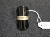a ring with a gold band on a black surface