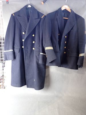 two coats hanging on a rack in a room