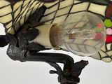 a close up of a lamp with a bird on it ' s head