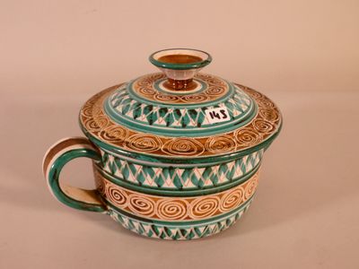 a teapot with a lid on a white table