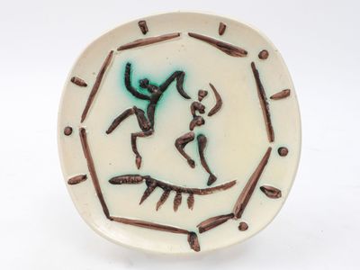 a white plate with a picture of a man and a woman on it