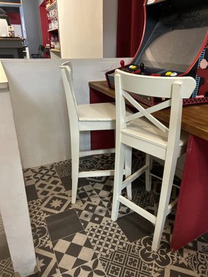 two chairs and a table with a suitcase on top of it