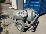 a small trailer with a propanent attached to it