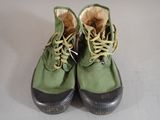 a pair of green shoes that are on a table