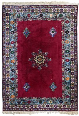 a red rug with a medallion design on it
