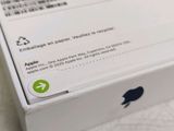 a white box with a green apple logo on it