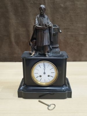 a statue of a man sitting on a table with a clock