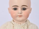 a close up of a doll with a necklace on it