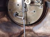 a close up of a clock that is on the wall