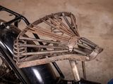 a close up of a motorcycle with a metal cage on the back