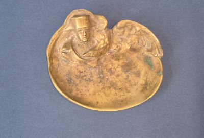 une image représentant une assiette en or sur laquelle figure un ange