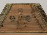 a wooden instrument that is sitting on a table