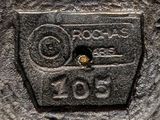 a close up of a metal plate with a number on it