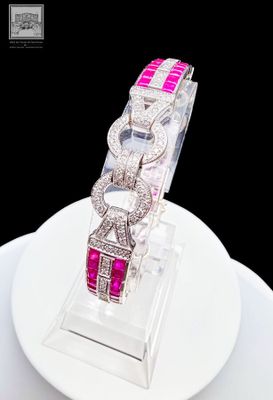a white plate with a pink and white watch on it