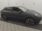 a grey porsche cayen is parked in a garage