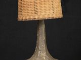 a wicker lamp with a wicker shade on it