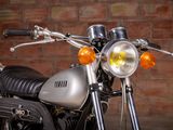 a motorcycle that is parked in front of a brick wall
