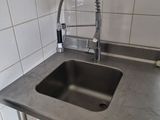 a sink with a faucet and a faucet on the counter