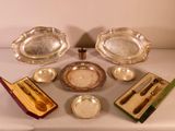 a lot of silverware on a table with a box