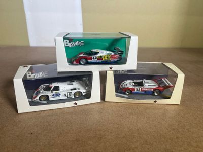 three model cars are sitting in a box on a table