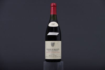 a bottle of wine sitting on top of a black table