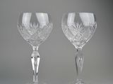 pair of cut crystal goblets on a grey background