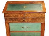 a wooden chest of drawers with a green leather top