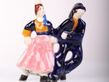 a figurine of a man and a woman riding a horse