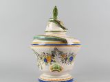 a white and blue vase with a bird on it