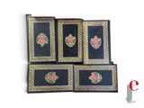 four black and gold book cases with roses on them