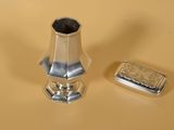 un briquet en argent et un étui à briquet posés sur une table