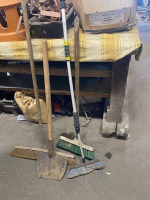 a pile of tools sitting on a bed in a garage