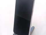 a cell phone that is on a stand on a table