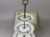a three tiered cake stand with plates on it