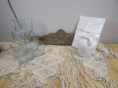 a picture of a table with a bottle of water and a vase on it