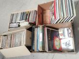 a lot of records in a box on the floor