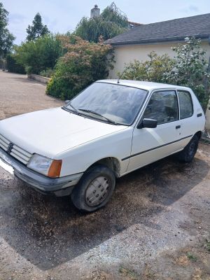 a white car that is parked in the dirt