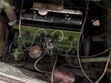 an old car with a green engine in the back