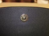 an image of a black chair with a button on it