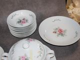 a lot of plates and bowls that are on the table