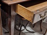 a desk with a chair and a mirror on the wall