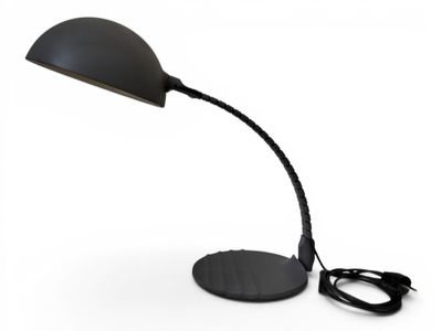the black desk lamp is on a white surface with a cord