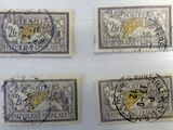 four different stamps with a lion on them on a white surface